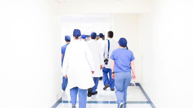 Health care workers walking down corridor